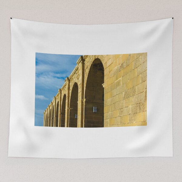 Item preview, Sunlit Stone Arched Colonnade Along Historic Building Facade Under Blue Sky designed and sold by Nmallia.