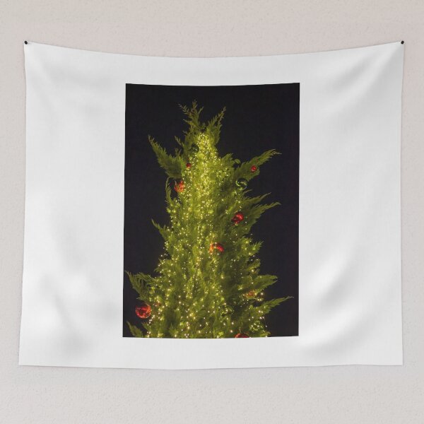 Item preview, Festive Christmas Tree Covered In Warm String Lights And Red Ornaments Against Night Sky designed and sold by Nmallia.