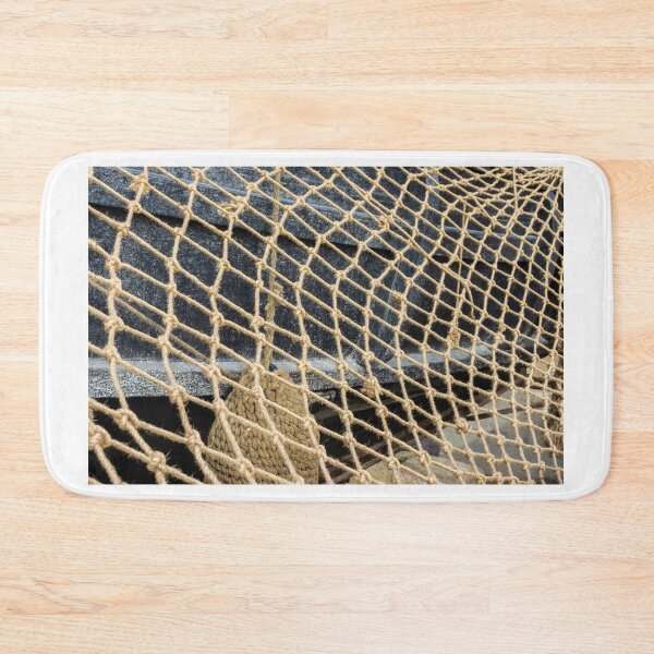 Item preview, Close-Up Of Rope Fishing Net Draped Over Weathered Wooden Boat Deck With Nautical Texture designed and sold by Nmallia.