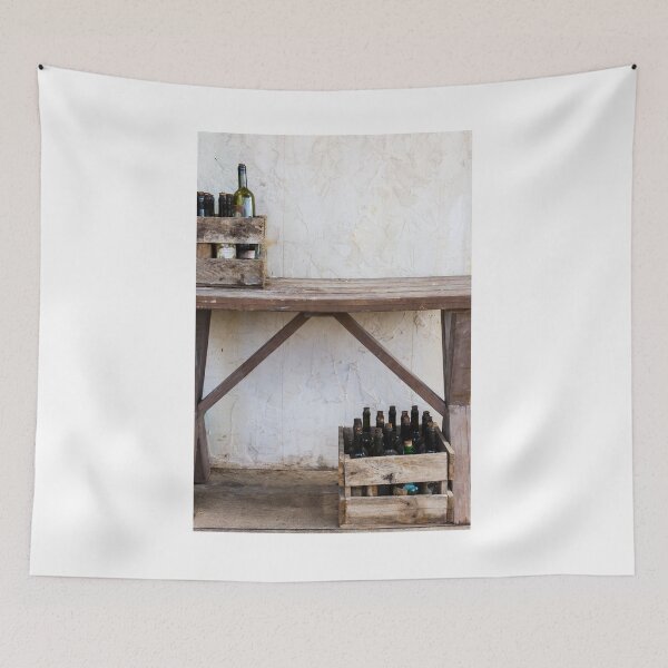 Item preview, Rustic Wooden Crates With Wine Bottles On Weathered Table Against Textured Plaster Wall designed and sold by Nmallia.