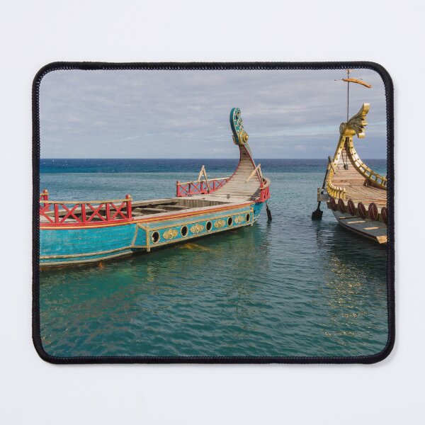 Item preview, Colorful Viking Boats Docked on Calm Sea Near Shore Under Cloudy Sky designed and sold by Nmallia.