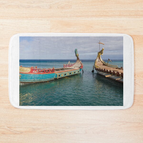 Item preview, Colorful Viking Boats Docked on Calm Sea Near Shore Under Cloudy Sky designed and sold by Nmallia.