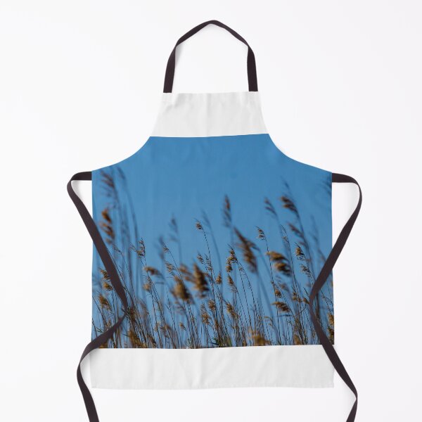 Item preview, Golden Reeds and Tall Grasses Swaying Against a Clear Blue Sky Over Coastal Marshland designed and sold by Nmallia.