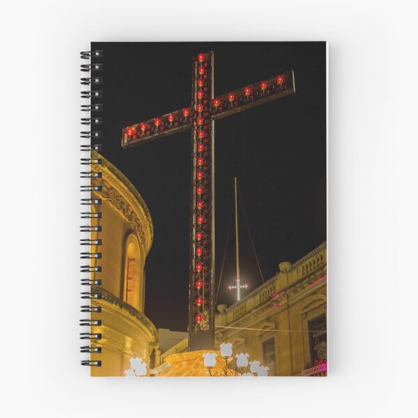 Item preview, Illuminated Red Light Cross At Night Above Historic Church Buildings And Street Lamps designed and sold by Nmallia.