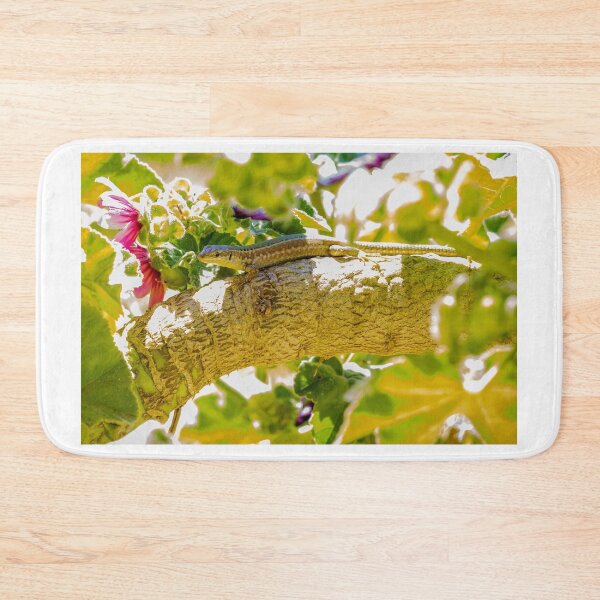 Item preview, Sunlit Lizard Resting on Tree Branch Among Green Leaves and Pink Garden Flowers designed and sold by Nmallia.