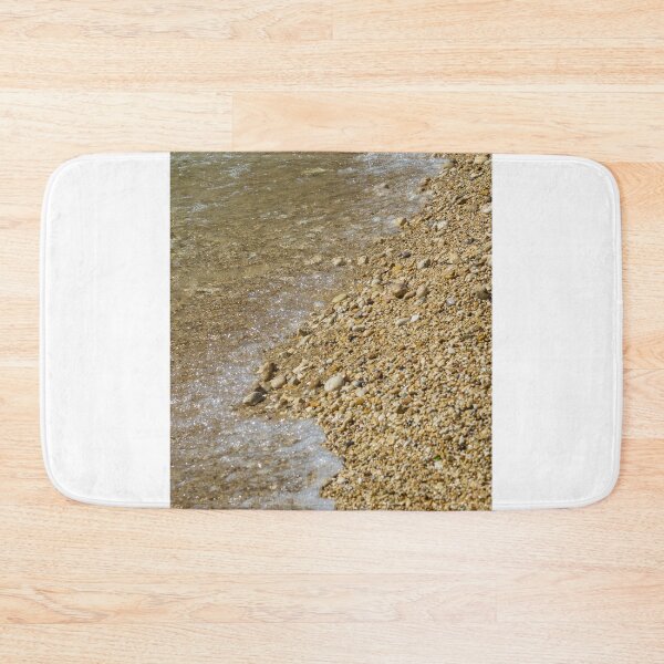 Item preview, Pebble Beach Shoreline With Clear Shallow Water, Gentle Wave Foam And Sunlit Stones designed and sold by Nmallia.