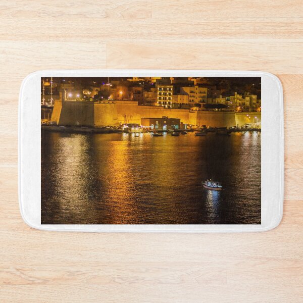 Item preview, Night Harbor With Small Boat and Historic Waterfront Fortress Illuminated by City Lights and Golden Reflections designed and sold by Nmallia.