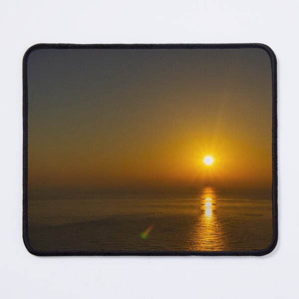Item preview, Puesta de sol dorada sobre un océano en calma con el reflejo del sol en el agua y la silueta de la costa. designed and sold by Nmallia.