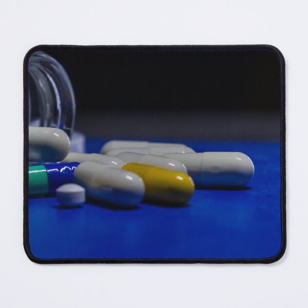 Item preview, Close-Up of Prescription Capsules and Tablets Spilling From a Glass Pill Bottle on Blue Surface designed and sold by Nmallia.