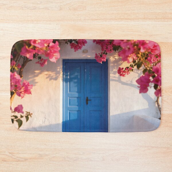 Item preview, Vibrant Pink Bougainvillea Flowers Framing a Blue Mediterranean Door on a White Wall designed and sold by Dezinix.