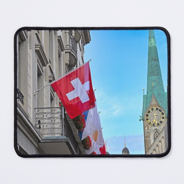 Item preview, A building with a Swiss flag and Grossmunster and Fraumunster church clock towers in the background, Zurich, Switzerland designed and sold by goceris.
