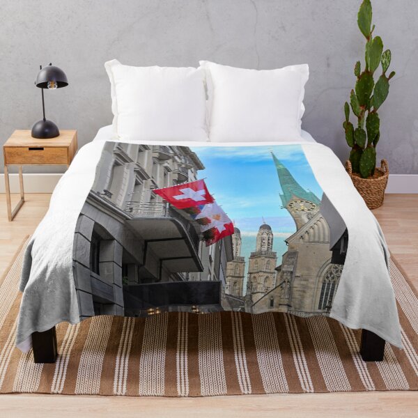 Item preview, A building with a Swiss flag and Grossmunster and Fraumunster church clock towers in the background, Zurich, Switzerland designed and sold by goceris.