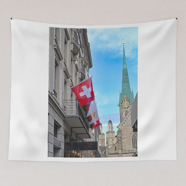 Artikelvorschau, Ein Gebäude mit Schweizer Flagge und den Kirchtürmen Grossmünster und Fraumünster im Hintergrund, Zürich, Schweiz entworfen und verkauft von goceris.