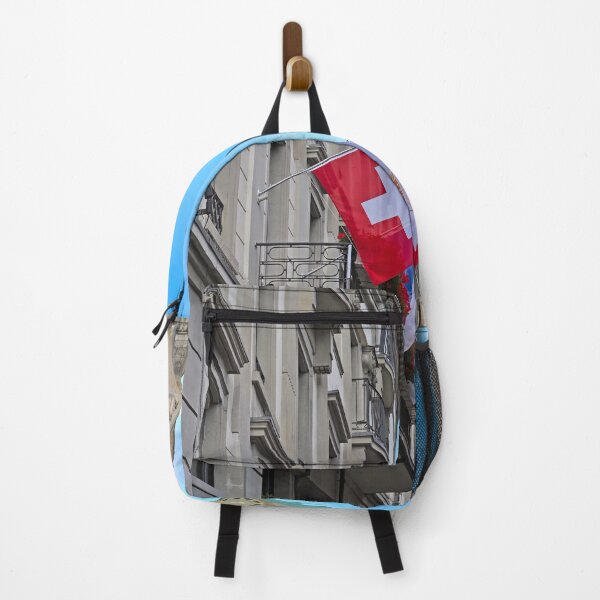 Item preview, A building with a Swiss flag and Grossmunster and Fraumunster church clock towers in the background, Zurich, Switzerland designed and sold by goceris.