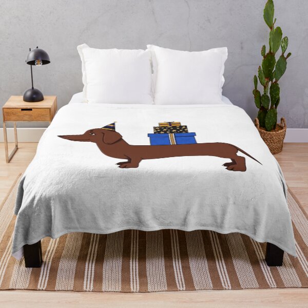 Item preview, Long brown dog wearing party hat carrying gift boxes designed and sold by ViniBall.