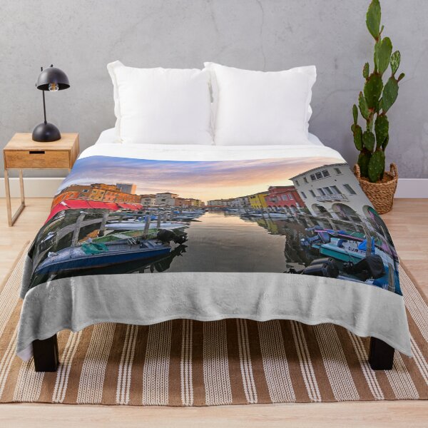 Item preview, Small boats floating in calm water, sunrise over town of Chioggia, Venetian Lagoon, Veneto, Italy. designed and sold by goceris.