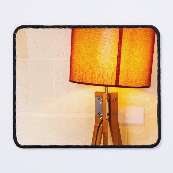 Item preview, Warm Wooden Tripod Floor Lamp With Orange Lampshade Against Stone Wall For Cozy Interior designed and sold by Nmallia.