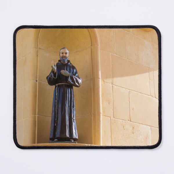 Item preview, Saint Statue In Church Niche On Stone Wall Evoking Faith And Quiet Devotion In Sunlight designed and sold by Nmallia.