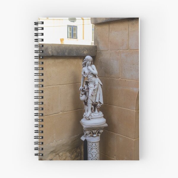 Item preview, Classical Marble Statue On Ornate Pedestal Against Stone Wall In Quiet Courtyard Nook designed and sold by Nmallia.
