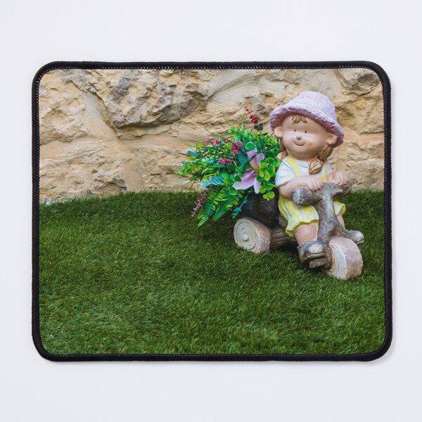 Item preview, Whimsical Garden Figurine Of Girl On Wooden Tricycle With Flowers Against Stone Wall designed and sold by Nmallia.