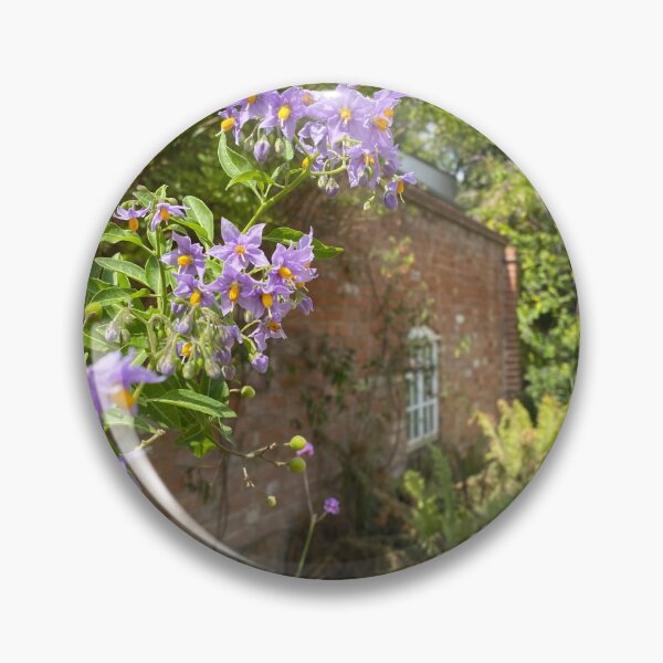 Item preview, Flowers in front of a brick building designed and sold by ForestedDesigns.