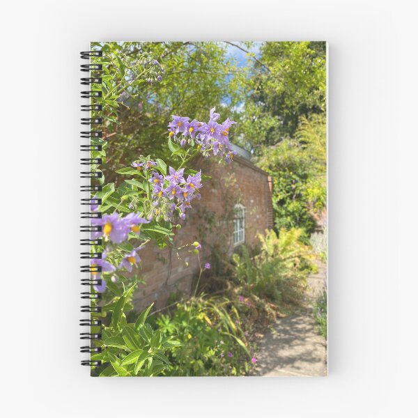 Item preview, Flowers in front of a brick building designed and sold by ForestedDesigns.