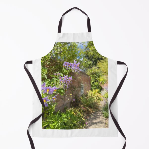 Item preview, Flowers in front of a brick building designed and sold by ForestedDesigns.