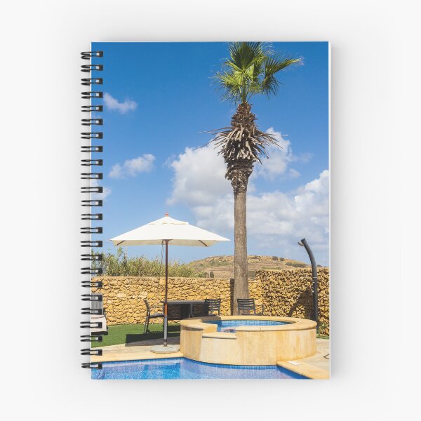Item preview, Sunny Resort Pool With Palm Tree, Umbrella and Lounge Chairs Overlooking Stone Wall and Blue Sky designed and sold by Nmallia.
