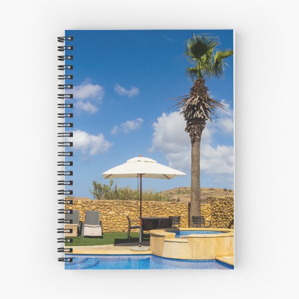 Item preview, Sunny Resort Pool With Palm Tree, Umbrella and Lounge Chairs Overlooking Stone Wall and Blue Sky designed and sold by Nmallia.