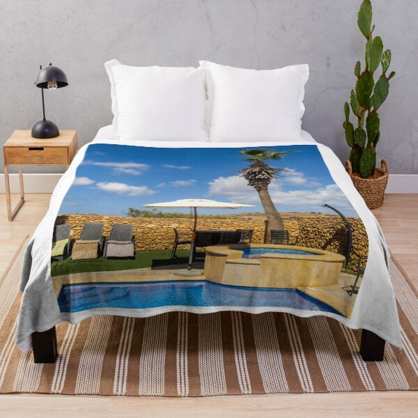 Item preview, Sunny Resort Pool With Palm Tree, Umbrella and Lounge Chairs Overlooking Stone Wall and Blue Sky designed and sold by Nmallia.