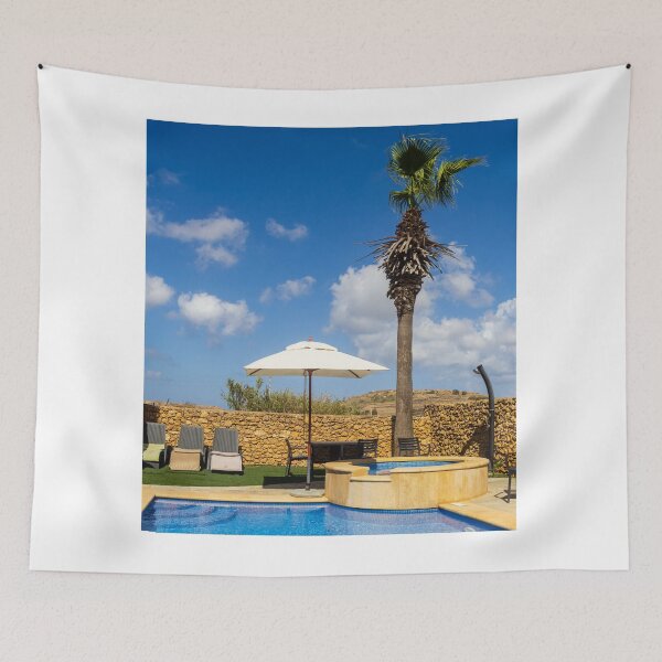 Item preview, Sunny Resort Pool With Palm Tree, Umbrella and Lounge Chairs Overlooking Stone Wall and Blue Sky designed and sold by Nmallia.