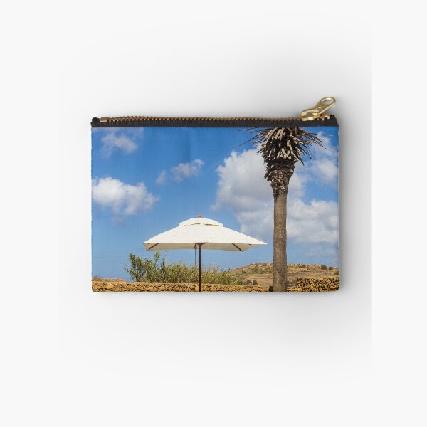 Item preview, Sunny Resort Pool With Palm Tree, Umbrella and Lounge Chairs Overlooking Stone Wall and Blue Sky designed and sold by Nmallia.