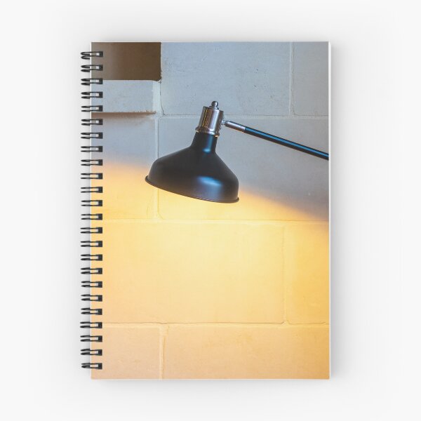 Item preview, Black Adjustable Desk Lamp Casting Warm Light on Textured Stone Wall in Cozy Interior designed and sold by Nmallia.