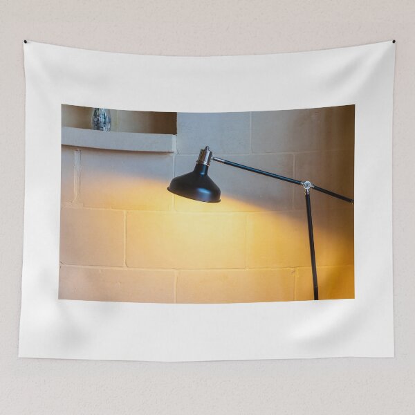 Item preview, Black Adjustable Desk Lamp Casting Warm Light on Textured Stone Wall in Cozy Interior designed and sold by Nmallia.