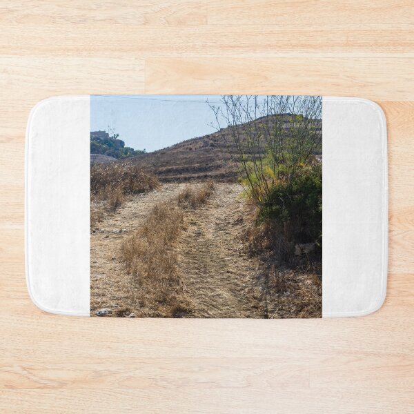 Item preview, Sunlit Stone Path Through Rural Mediterranean Village Between Dry Stone Walls Overlooking Coast designed and sold by Nmallia.