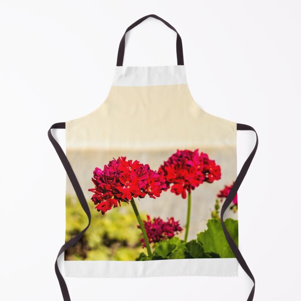 Item preview, Close-up red geranium flowers in a sunny garden with green leaves and soft background bokeh designed and sold by Nmallia.