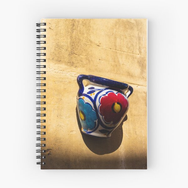 Item preview, Colorful Ceramic Wall Pot With Floral Design Casting Shadow On Rustic Sunlit Stone designed and sold by Nmallia.