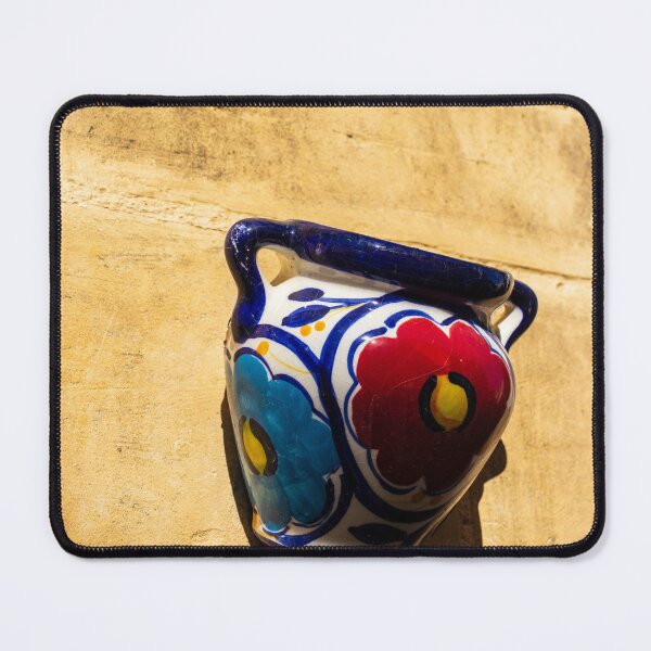 Item preview, Colorful Ceramic Wall Pot With Floral Design Casting Shadow On Rustic Sunlit Stone designed and sold by Nmallia.