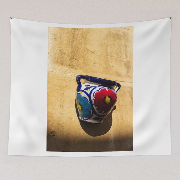 Item preview, Colorful Ceramic Wall Pot With Floral Design Casting Shadow On Rustic Sunlit Stone designed and sold by Nmallia.