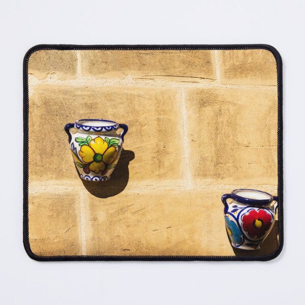 Item preview, Colorful Ceramic Wall Pot With Floral Design Casting Shadow On Rustic Sunlit Stone designed and sold by Nmallia.