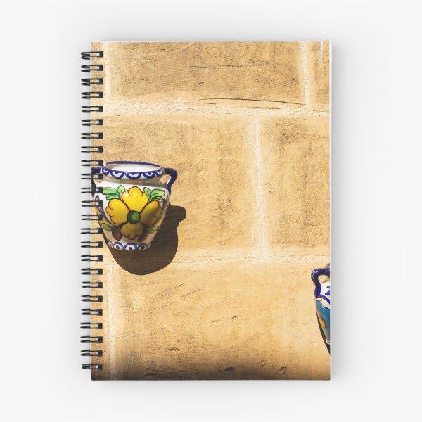Item preview, Colorful Ceramic Wall Pot With Floral Design Casting Shadow On Rustic Sunlit Stone designed and sold by Nmallia.