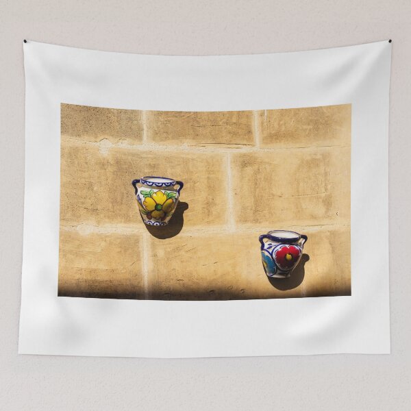Item preview, Colorful Ceramic Wall Pot With Floral Design Casting Shadow On Rustic Sunlit Stone designed and sold by Nmallia.