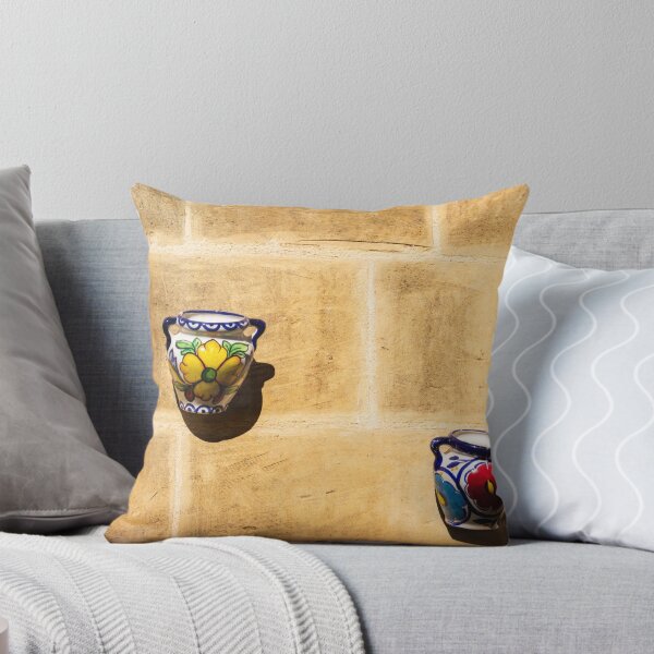 Item preview, Colorful Ceramic Wall Pot With Floral Design Casting Shadow On Rustic Sunlit Stone designed and sold by Nmallia.