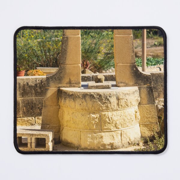 Item preview, Sunlit Stone Well in Rustic Mediterranean Countryside With Sea View and Historic Architecture designed and sold by Nmallia.