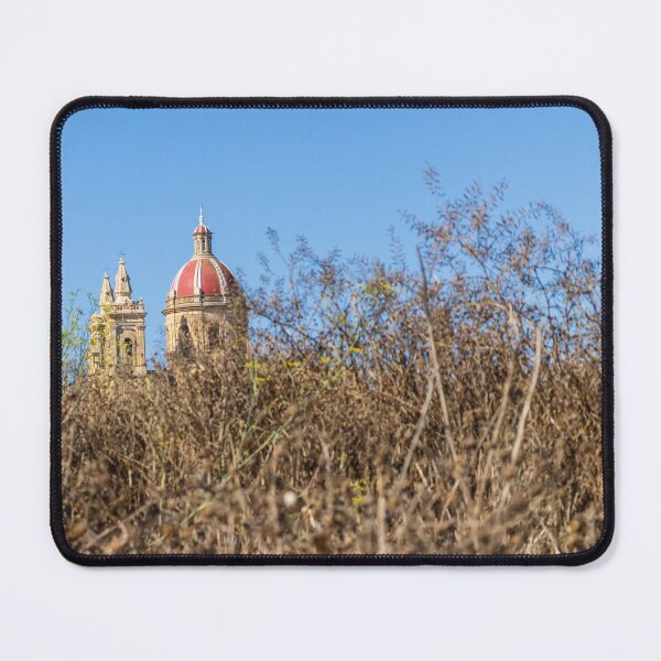 Item preview, Historic Cathedral Dome Peeking Above Dry Grass With Clear Blue Sky Background designed and sold by Nmallia.