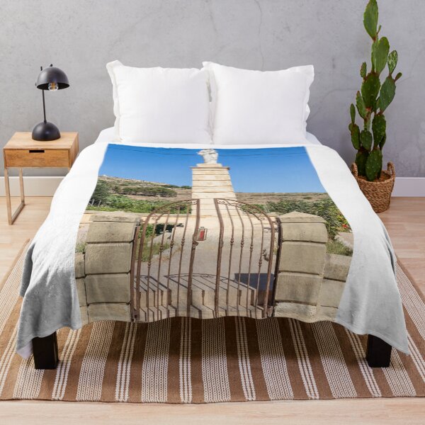 Item preview, Stone Madonna Statue on Pillar Behind Wrought Iron Gate at Rural Shrine Under Blue Sky designed and sold by Nmallia.