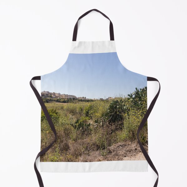 Item preview, Prickly Pear Cactus in Sunny Dry Field Near Low-Rise Town Buildings Under Clear Blue Sky designed and sold by Nmallia.