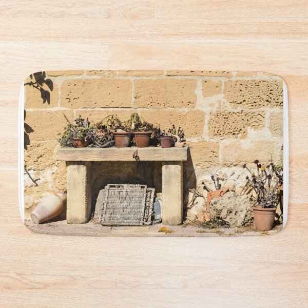 Item preview, Rustic Stone Wall With Weathered Bench and Potted Plants in Sunny Mediterranean Courtyard designed and sold by Nmallia.