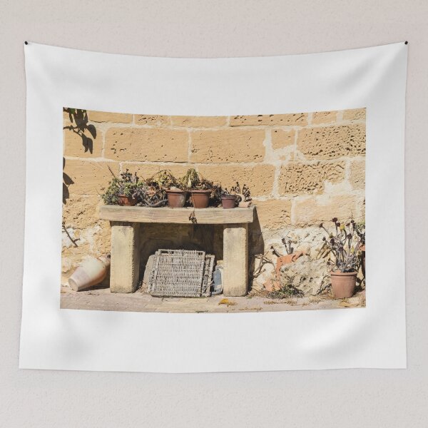 Item preview, Rustic Stone Wall With Weathered Bench and Potted Plants in Sunny Mediterranean Courtyard designed and sold by Nmallia.