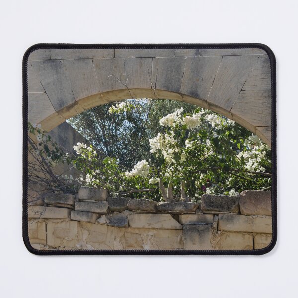 Item preview, Stone Arch Window With White Bougainvillea Blossoms Over Sunlit Mediterranean Ruin Wall designed and sold by Nmallia.